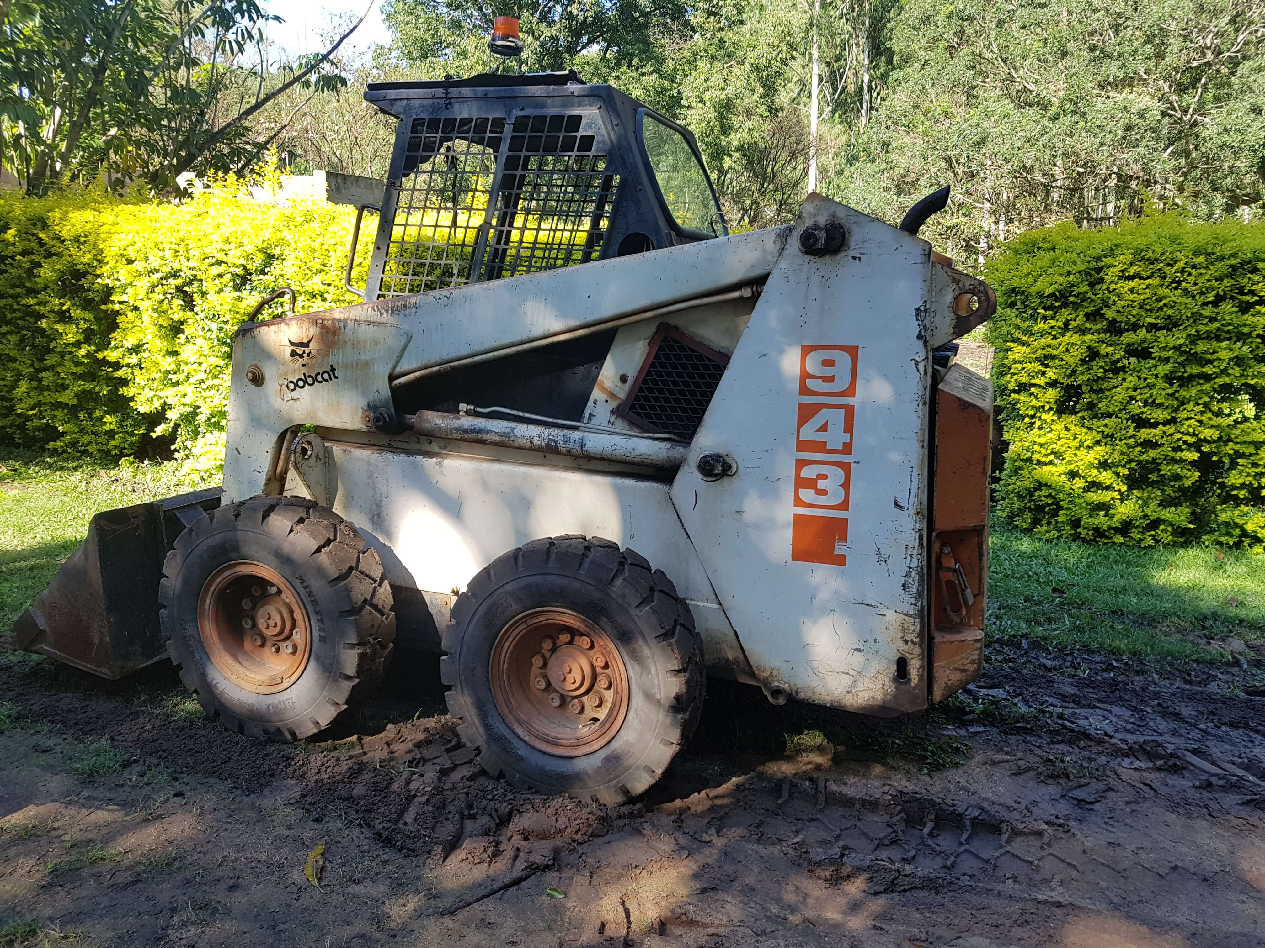 Versatile compact machine for clearing and moving building materials on small sites and gardens, or where access is limited